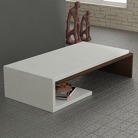 Minimalist coffee table with dramatic shape and compact profile