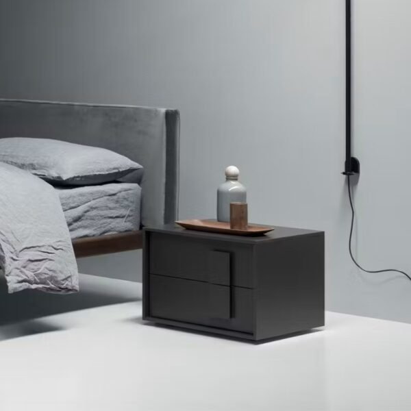 Close-up of styled drawer handles on dark grey bedside unit
