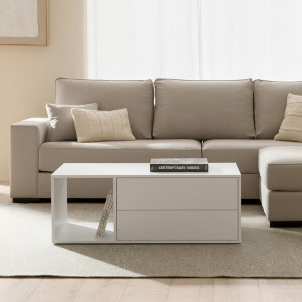 Modern white coffee table with drawers in a living room